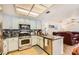 Open kitchen with light colored cabinets, stainless steel appliances, tile backsplash, and open to the living room at 333 Abbington St, Henderson, NV 89074