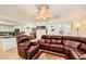 Open-concept living room with tile floors, comfortable leather seating and views of the kitchen and dining area at 333 Abbington St, Henderson, NV 89074