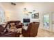 Living room with tile flooring, a ceiling fan, and a door to the private patio, filled with comfortable furniture at 333 Abbington St, Henderson, NV 89074
