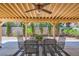 Outdoor patio area shaded by a pergola, furnished with a glass-top table and six metal chairs at 333 Abbington St, Henderson, NV 89074