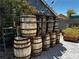 Creative backyard featuring wooden barrel decor, planters, and a ladder trellis at 3601 Slapton Ave, North Las Vegas, NV 89031