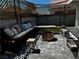 Inviting backyard patio with ample seating, fire pit, stylish pavers, and privacy fencing at 3601 Slapton Ave, North Las Vegas, NV 89031
