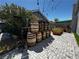 Creative backyard featuring wooden barrel decor, planters, ladder trellis, and artificial turf at 3601 Slapton Ave, North Las Vegas, NV 89031