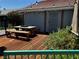 Cozy backyard deck with picnic table, benches, string lights, and privacy fencing at 3601 Slapton Ave, North Las Vegas, NV 89031
