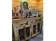 Custom wood bar with full display of spirits and storage cabinets with wrought iron detailing at 3601 Slapton Ave, North Las Vegas, NV 89031