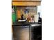 Custom bar with a tap, wooden backsplash and wine glass rack, adding a unique touch for entertaining at 3601 Slapton Ave, North Las Vegas, NV 89031