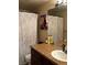 Well-lit bathroom with white marble shower curtain, enhancing the space's modern aesthetic at 3601 Slapton Ave, North Las Vegas, NV 89031