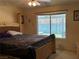 Cozy bedroom with plush bedding and a view to the backyard, creating a serene retreat at 3601 Slapton Ave, North Las Vegas, NV 89031