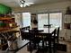 View of the dining area with a large wooden table set, chairs, and custom bar at 3601 Slapton Ave, North Las Vegas, NV 89031
