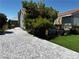 Long paved driveway and landscaping add beauty to the property's exterior at 3601 Slapton Ave, North Las Vegas, NV 89031