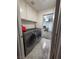 Efficient laundry room featuring front-loading washer and dryer, with upper cabinet storage at 3601 Slapton Ave, North Las Vegas, NV 89031