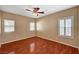 Spacious bedroom featuring hardwood floors, a ceiling fan, and multiple windows at 3609 Blue Pimpernel Ave, North Las Vegas, NV 89081