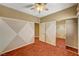 Bedroom features hardwood floors, ceiling fan, and mirrored closet at 3609 Blue Pimpernel Ave, North Las Vegas, NV 89081