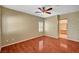 Bedroom with hardwood floors, ceiling fan, and plantation shutters at 3609 Blue Pimpernel Ave, North Las Vegas, NV 89081