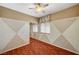Neutral bedroom featuring wood floors, ceiling fan, and a mirrored closet at 3609 Blue Pimpernel Ave, North Las Vegas, NV 89081