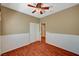 Bedroom featuring wood floors, ceiling fan, and bi-fold closet doors at 3609 Blue Pimpernel Ave, North Las Vegas, NV 89081