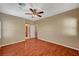 Large bedroom with wood floors, a ceiling fan, and direct access to the bathroom at 3609 Blue Pimpernel Ave, North Las Vegas, NV 89081
