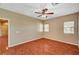 Bedroom with hardwood floors, ceiling fan, and natural light from two windows at 3609 Blue Pimpernel Ave, North Las Vegas, NV 89081