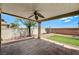 This covered patio has a ceiling fan and pillars overlooking a low-maintenance backyard at 3609 Blue Pimpernel Ave, North Las Vegas, NV 89081