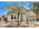 Charming single-story home featuring a two-car garage and desert landscaping at 3609 Blue Pimpernel Ave, North Las Vegas, NV 89081