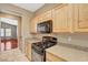 Galley kitchen design with granite counters, stainless steel sink and modern appliances at 3609 Blue Pimpernel Ave, North Las Vegas, NV 89081