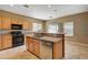 Bright kitchen featuring a large island with stainless steel appliances and modern lighting at 3609 Blue Pimpernel Ave, North Las Vegas, NV 89081