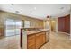 Kitchen island with stainless sink and hardware, granite countertops, and backyard view at 3609 Blue Pimpernel Ave, North Las Vegas, NV 89081