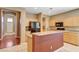 Open kitchen showcasing an island with granite countertops and ample cabinet space at 3609 Blue Pimpernel Ave, North Las Vegas, NV 89081