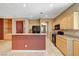 Bright kitchen featuring granite counters, light wood cabinets, and black appliances at 3609 Blue Pimpernel Ave, North Las Vegas, NV 89081