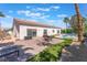 Backyard with a paved patio, artificial turf, and a pool, creating a resort-like atmosphere at 4116 Villa Flora St, Las Vegas, NV 89130