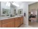Bathroom featuring a double-sink vanity and ample lighting, connecting to a walkway at 4116 Villa Flora St, Las Vegas, NV 89130
