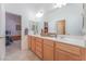 Bathroom featuring double sink vanity with framed mirror and door to bedroom at 4116 Villa Flora St, Las Vegas, NV 89130