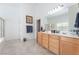 Elegant primary bathroom with a soaking tub, glass shower, dual sinks, and neutral tile flooring at 4116 Villa Flora St, Las Vegas, NV 89130