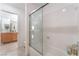 Bathroom featuring a white tub with a sliding glass door and neutral tile flooring at 4116 Villa Flora St, Las Vegas, NV 89130