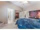 Spacious bedroom with soft carpet, a ceiling fan, and a view of a study nook in the ensuite bathroom at 4116 Villa Flora St, Las Vegas, NV 89130