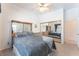 Bright bedroom featuring a window with curtains, a ceiling fan, and mirrored closet doors at 4116 Villa Flora St, Las Vegas, NV 89130