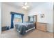 Charming bedroom featuring a window with curtains, a ceiling fan, and ample natural light at 4116 Villa Flora St, Las Vegas, NV 89130