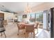 Bright dining area with chandelier, fireplace, and sliding doors to outdoor patio at 4116 Villa Flora St, Las Vegas, NV 89130
