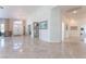 Open foyer featuring high ceilings, elegant chandelier, tile flooring, and intricate wall details at 4116 Villa Flora St, Las Vegas, NV 89130