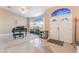 Elegant foyer with a grand piano, a curved blue couch, and a decorative mosaic tiled floor at 4116 Villa Flora St, Las Vegas, NV 89130