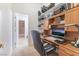 Functional home office with wooden desk, cabinets and shelves, offering ample storage space at 4116 Villa Flora St, Las Vegas, NV 89130