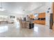 Bright, open kitchen boasts an island with seating and light wood cabinetry and an adjacent eating area at 4116 Villa Flora St, Las Vegas, NV 89130