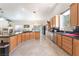 Spacious kitchen with black countertops, wood cabinets, stainless appliances, and adjacent dining area at 4116 Villa Flora St, Las Vegas, NV 89130