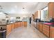 Spacious kitchen with black countertops, wood cabinets, stainless appliances, and adjacent dining area at 4116 Villa Flora St, Las Vegas, NV 89130