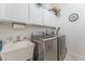 Laundry room with modern appliances, storage cabinets, and a sink for added convenience at 4116 Villa Flora St, Las Vegas, NV 89130