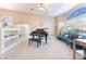 Comfortable living room featuring a grand piano, a blue curved couch, and bright natural lighting at 4116 Villa Flora St, Las Vegas, NV 89130