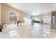 Expansive living room featuring tile flooring, large windows, and a grand piano at 4116 Villa Flora St, Las Vegas, NV 89130