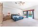 Inviting primary bedroom with blue bedding, neutral carpet, and patio access to a serene pool area at 4116 Villa Flora St, Las Vegas, NV 89130