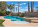 Backyard pool with hot tub, palm trees, a diving board and clear blue sky at 4116 Villa Flora St, Las Vegas, NV 89130