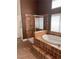 Bright bathroom showcasing a tub with tile surround and a glass-enclosed shower area at 5005 Wild Thyme Ave, Las Vegas, NV 89131